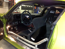 SEMA featured 1972 Camaro is equipped with custom seats, steering wheel, Tiger Cage, Autometer guage, shifter, shifter boot, floor pedals, rear view mirror, fire extinguisher and more
