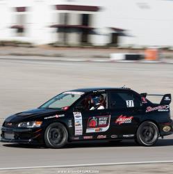 Driver side view of Ken Twhaits behind the wheel at Las Vegas Motor Speedway for OUSCI