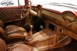 1955 Chevy Nomad passenger side interior shot featuring custom leather seats, console and dash pa