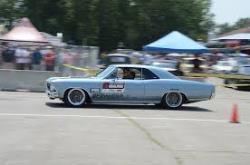 Driver side view of Chris Jacobs behind the wheel on the autocross track.