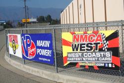 Event and Vendor banners at Autoclub Speedway, adjacent the sound wall.