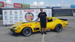 Photo of Chris Smith in front of the Goodguys Winner banner at the Lone Star Nationals in Texas