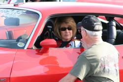 Husband David Pozzi seen coaching Mary as she sits in the driver's seat.